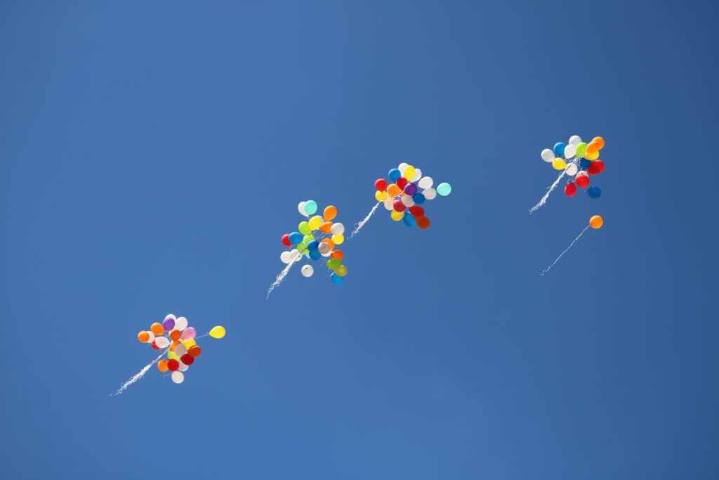 Groups of balloons flying away together