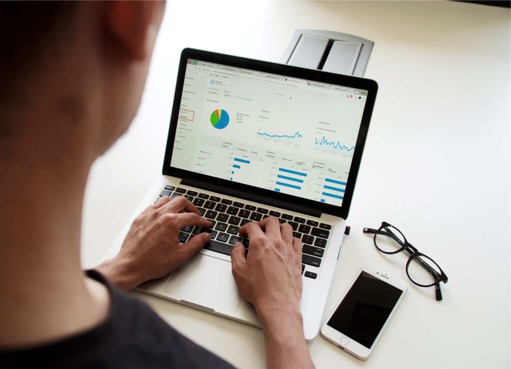 Image of an analyst working with data on a laptop