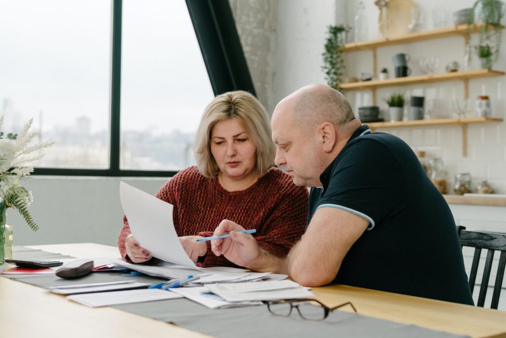 Two people looking at bills