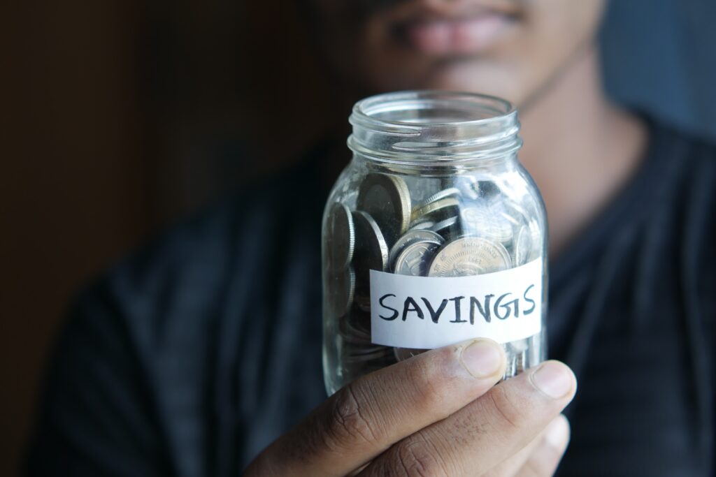 Man holding a savings jar